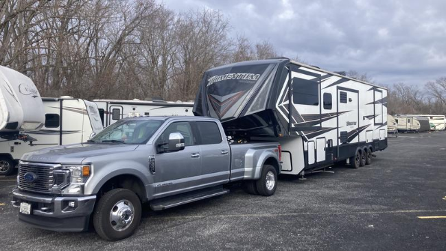 A camper being towed by a truck