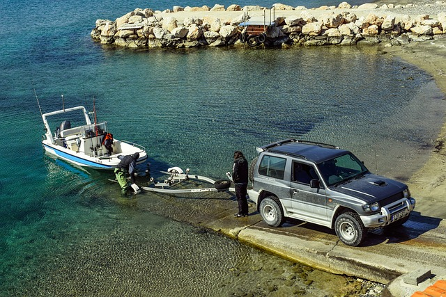 A car towing a boat out of the sea