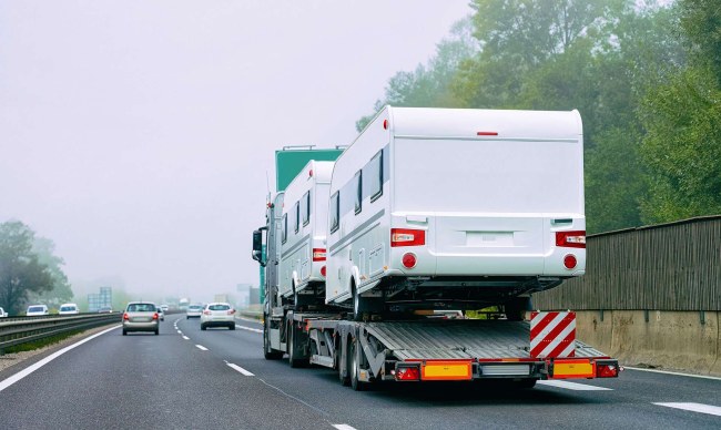 An RV on a flat_bed trailer 