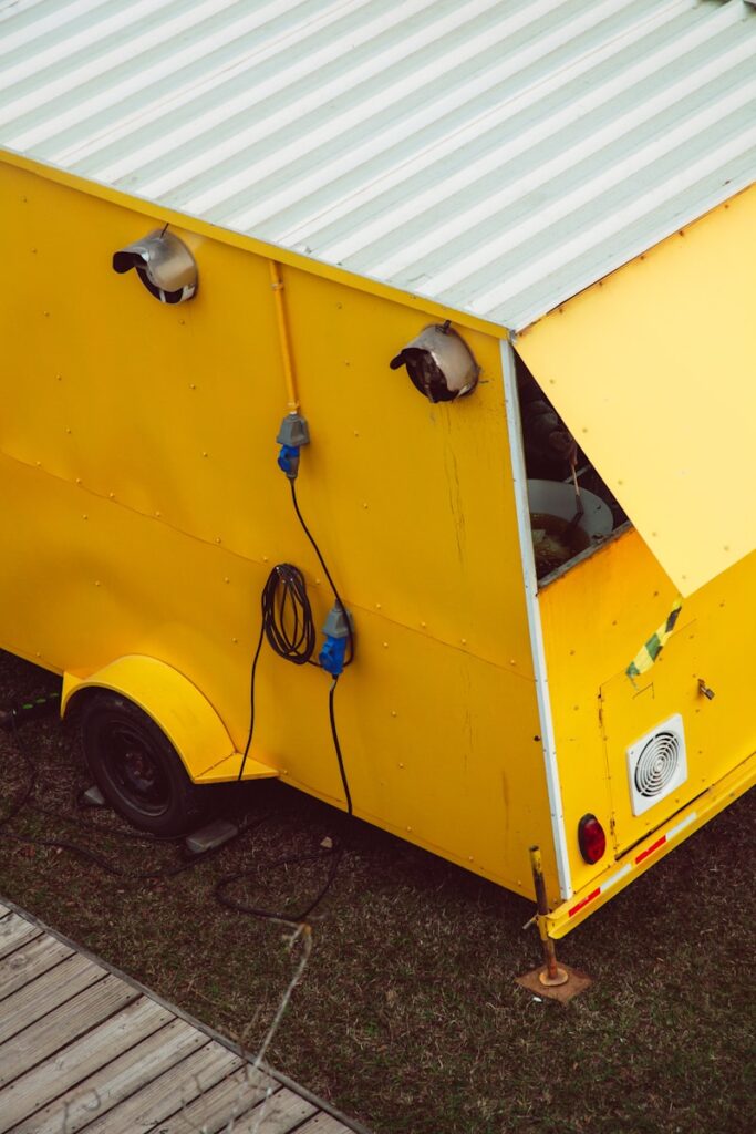 A yellow food truck parked on the side of a road