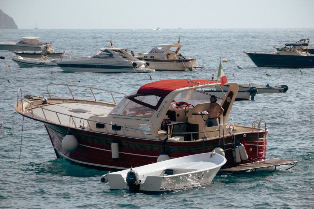 Boats are floating in the sea on a sunny day.