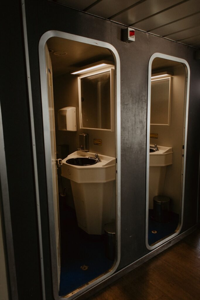 a bathroom with a sink and two mirrors