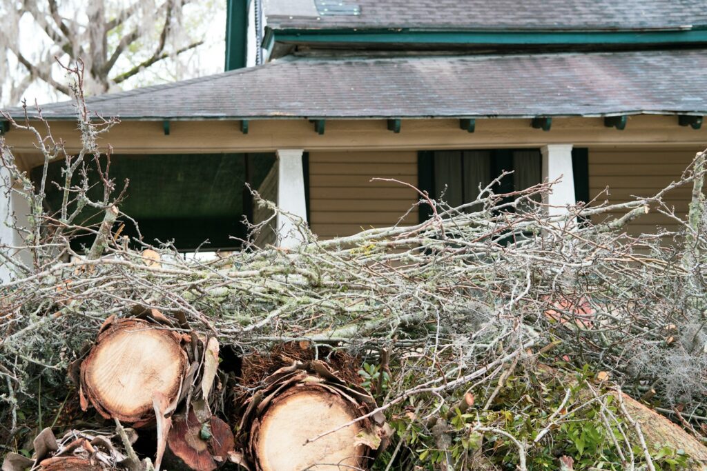 A pile of logs sitting in front of a house