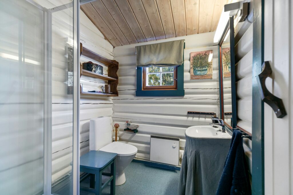 A bathroom with a shower, toilet and sink