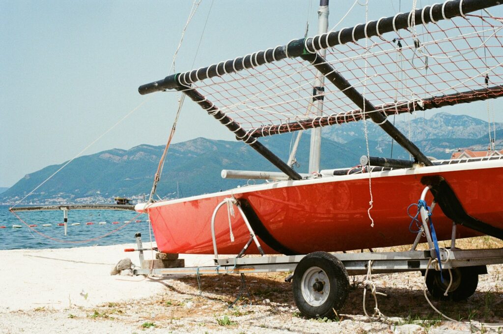 red and white boat on beach during daytime