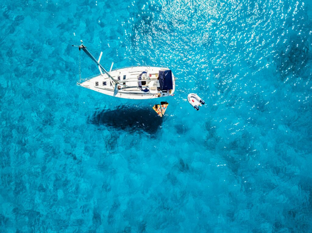white yacht in middle of blue sea