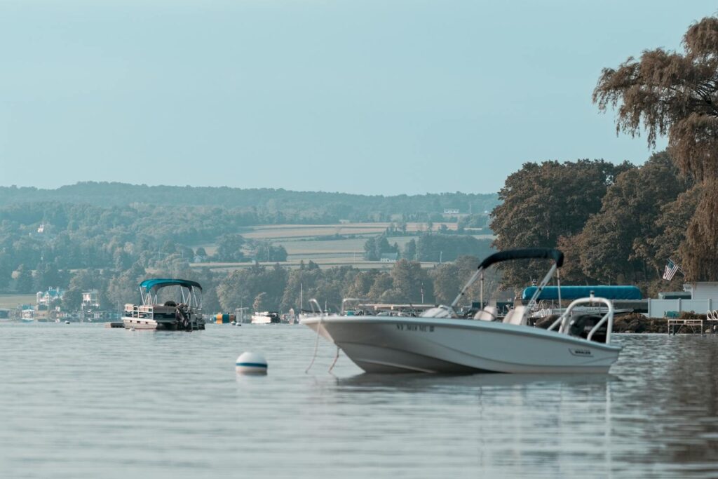 Peaceful scene of boats on Skaneateles Lake, New York, with a serene landscape backdrop.