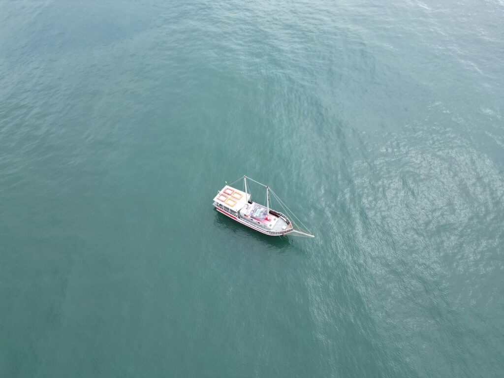 a small boat floating on top of a large body of water