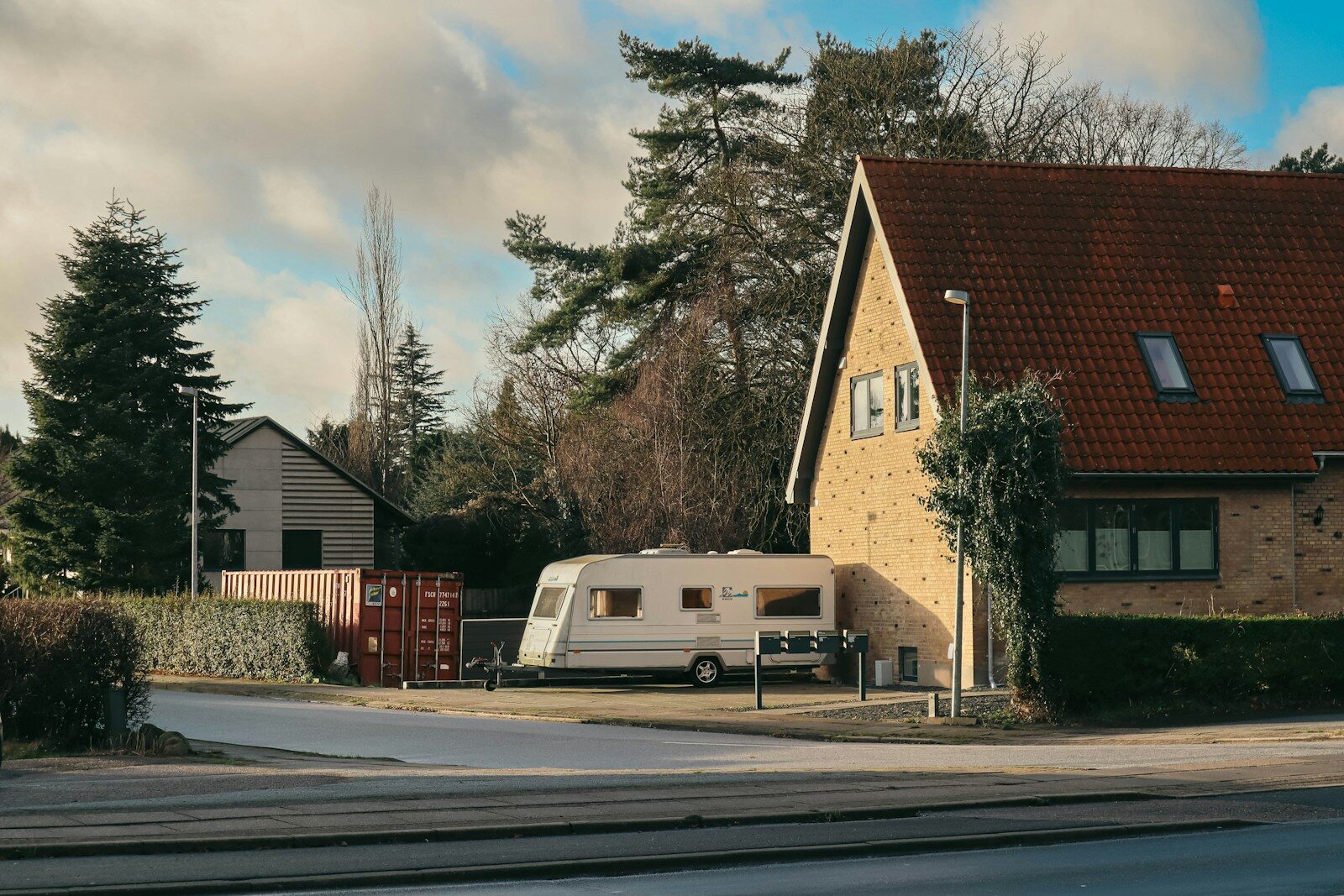 Caravan parked next to a brick house