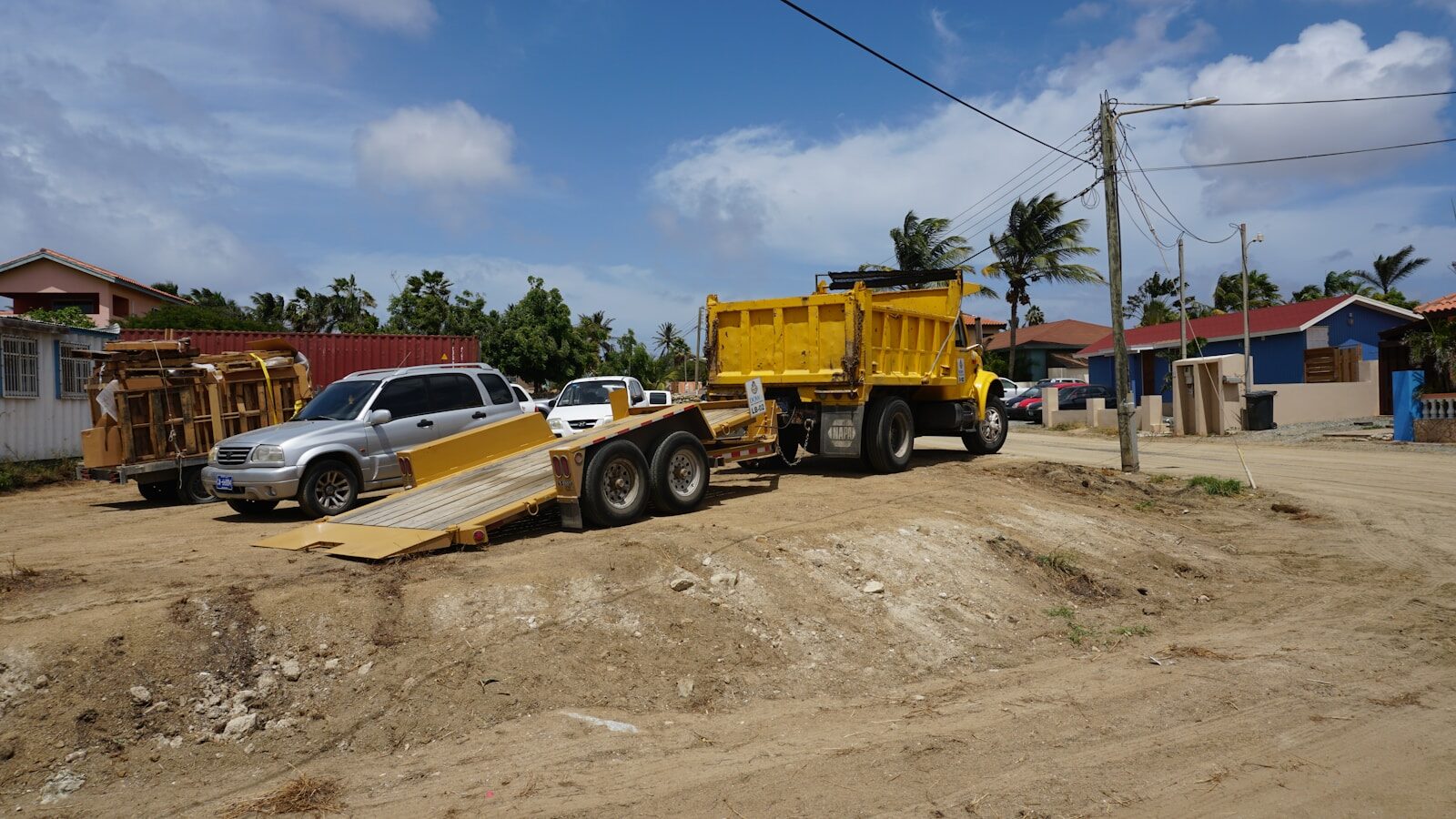 Photo by Brian J. Tromp Yellow dump truck towing a trailer