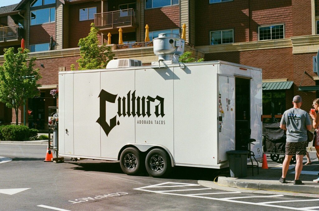 A white trailer parked on the side of a road
