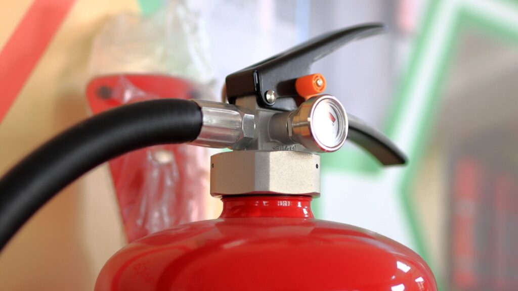 A red fire extinguisher close-up.