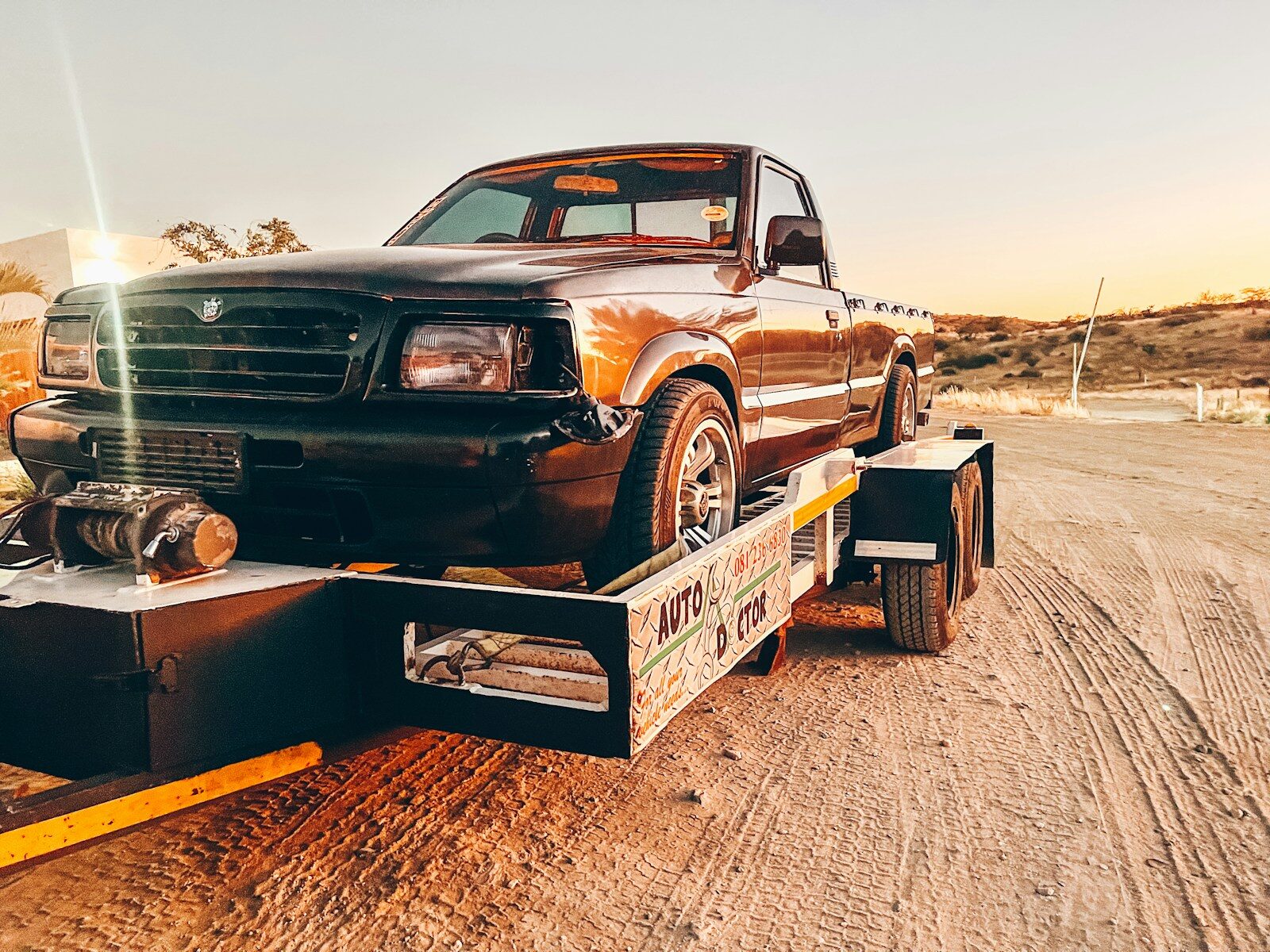 Photo by Zanelle Lofty-Eaton a truck is being towed on a flatbed trailer