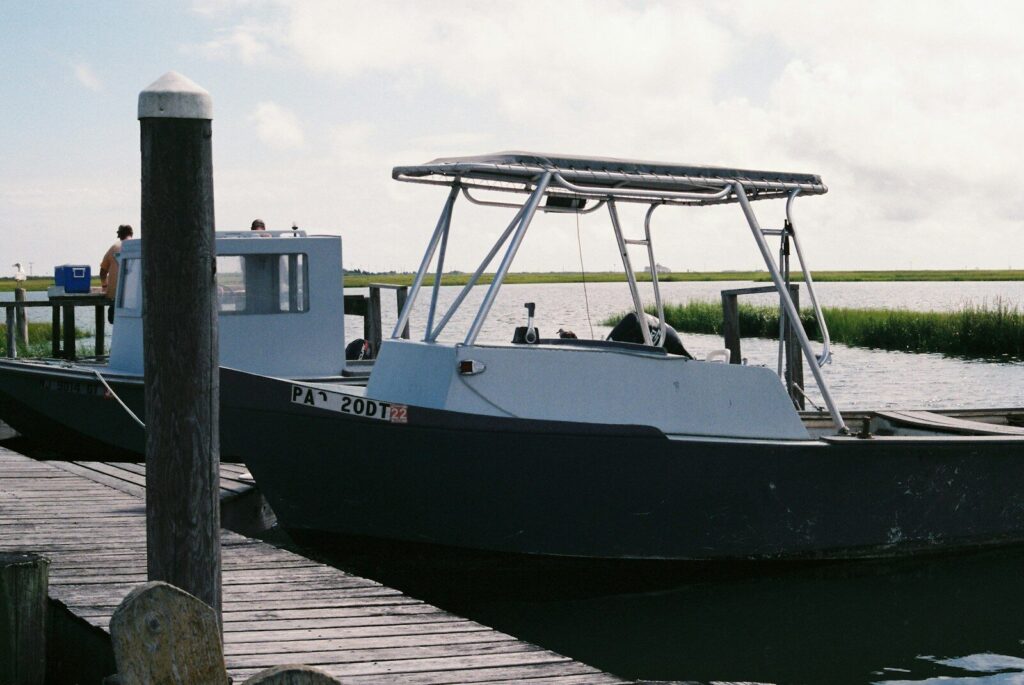 a boat docked at a pier with people on it