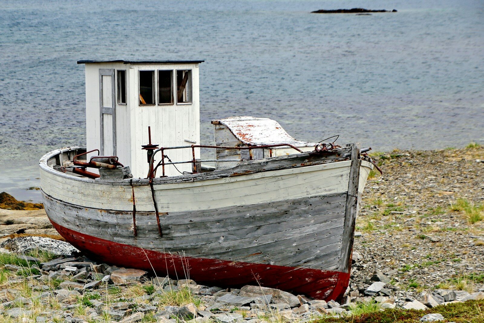 Photo by Mark König red and white boat on shore during daytime
