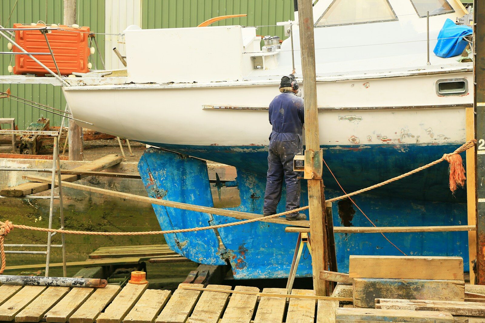 Photo by Nareeta Martin man in blue denim jacket standing on brown wooden dock during daytime