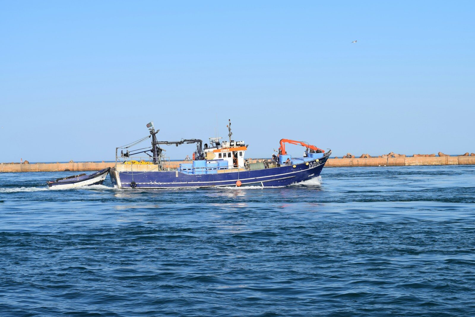 black and orange boat on sea during daytime