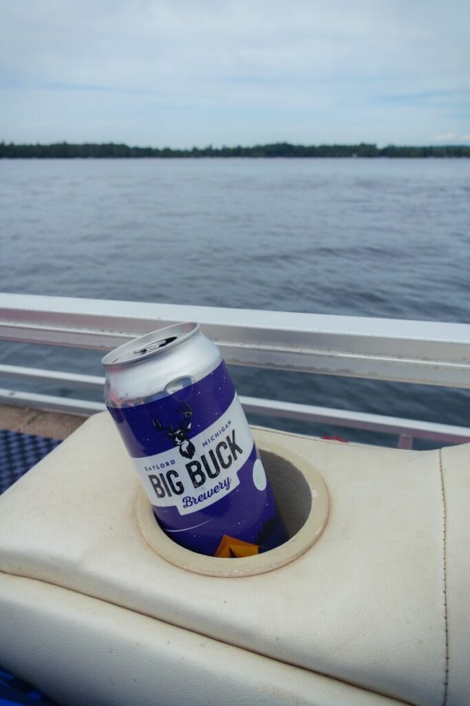 A can of beer sitting on the back of a boat