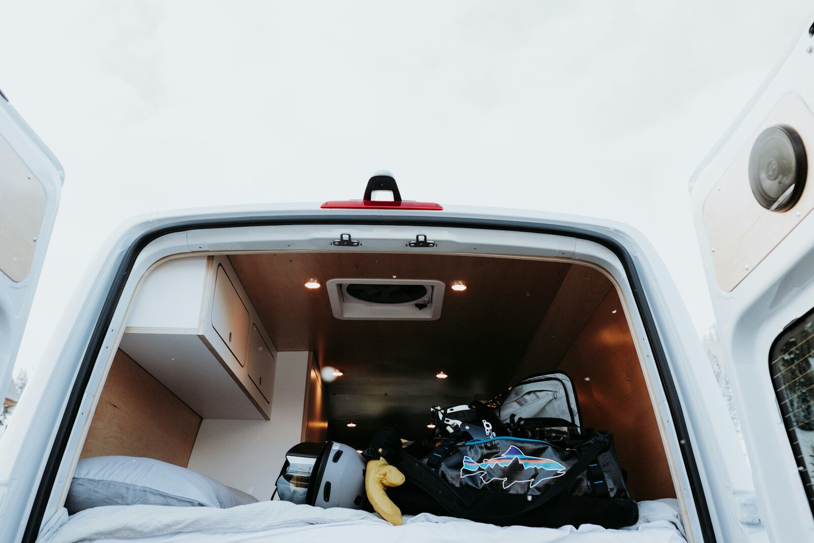 the back of a white van with luggage in it
