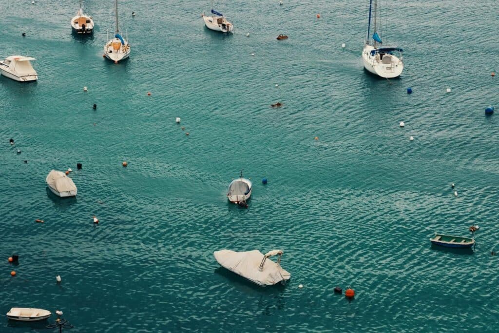 Peaceful view of boats floating in Valletta's turquoise waters, capturing leisure and travel vibes.