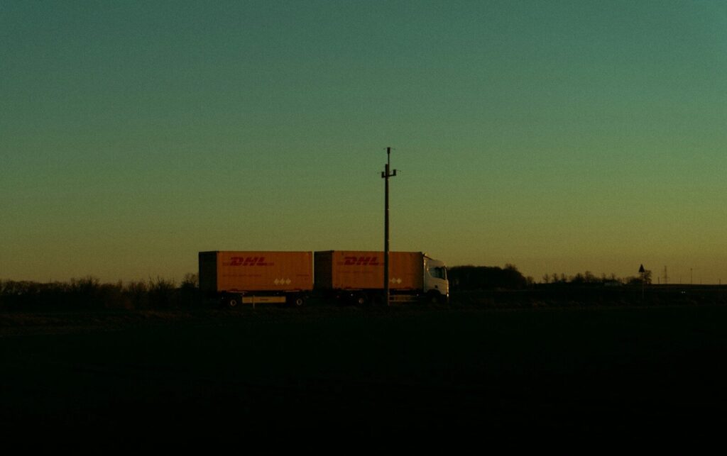 Semi-truck silhouetted against a twilight sky.