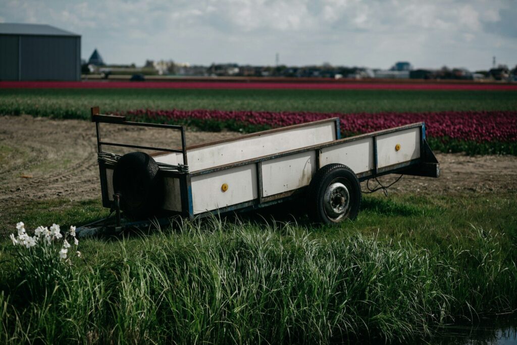 A trailer parked in a field next to a body of water