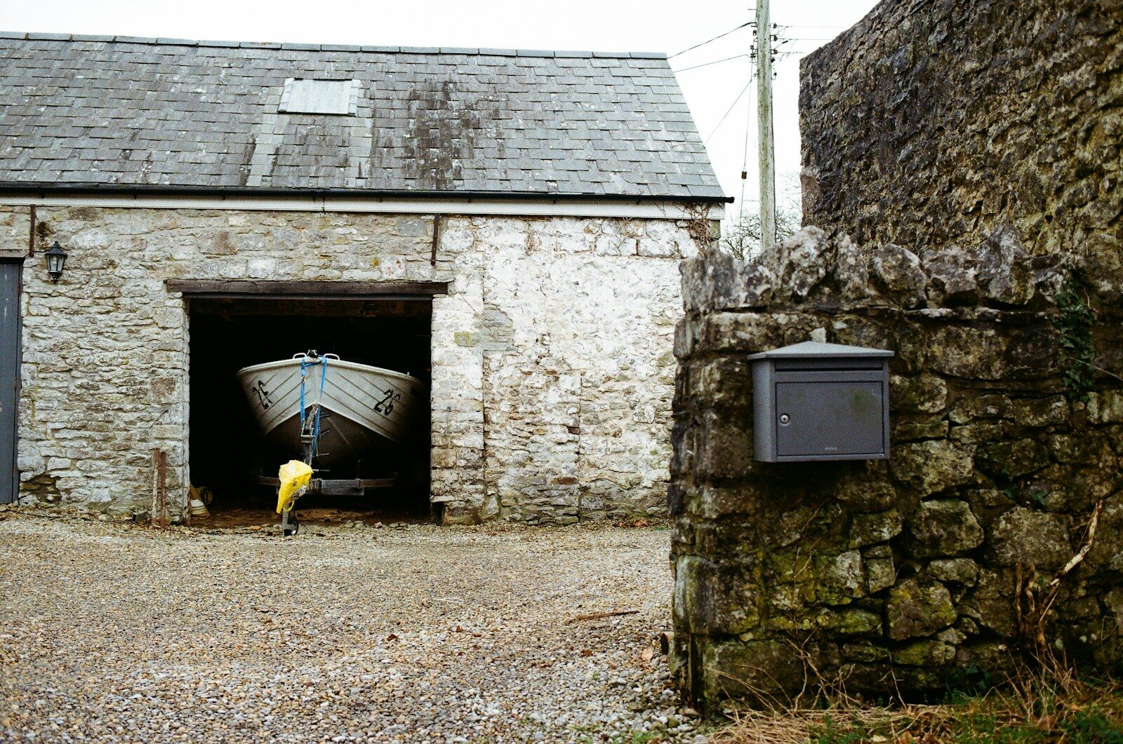 Boat inside a stone building with a mailbox Boat Trailer Maintenance and How Hard It Really Is to Pull One