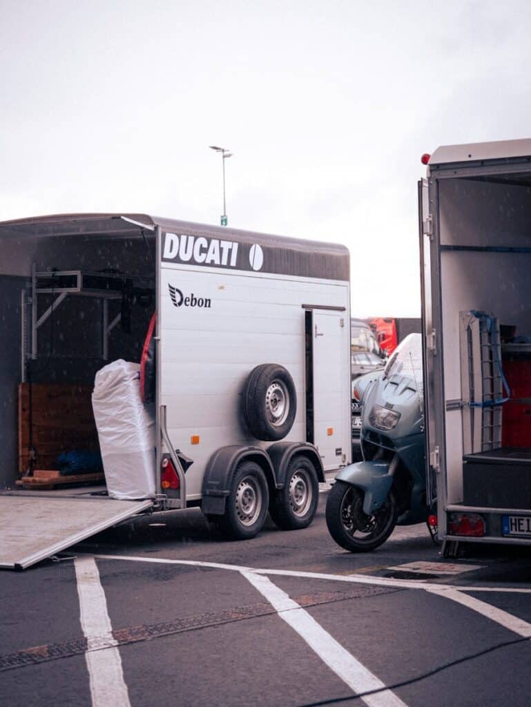 A ducati trailer with a motorcycle is parked.