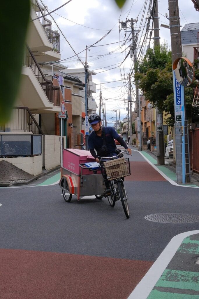 Man riding cargo bike through city street
