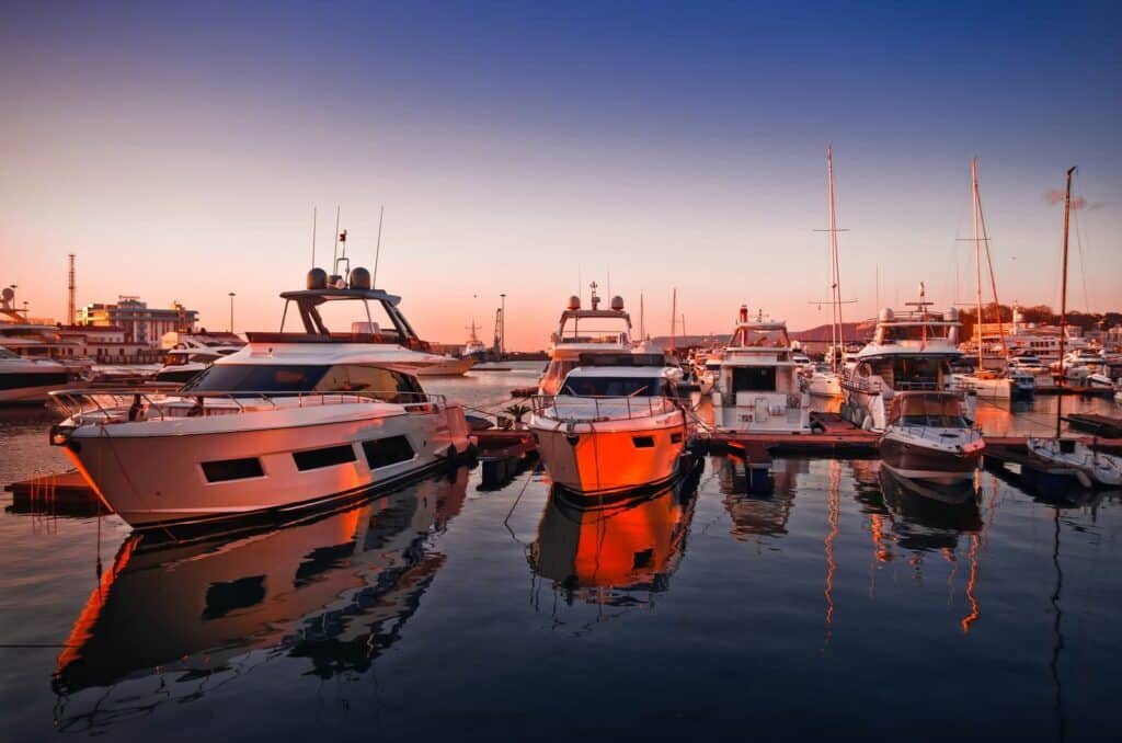 Captivating view of luxury yachts docked at Sochi Marina during a vibrant sunset.