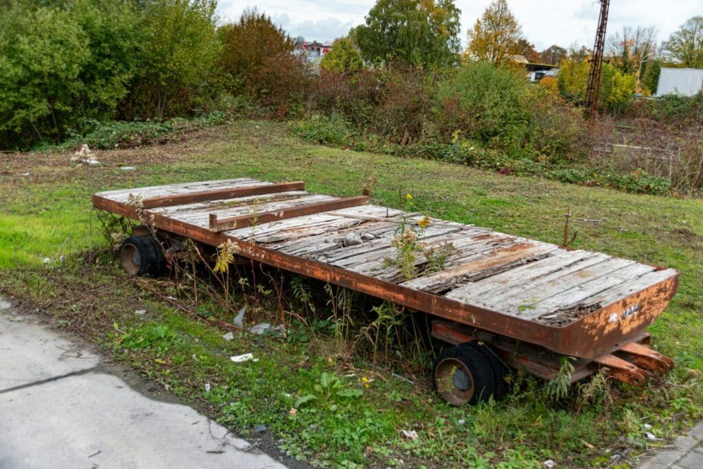 Old wooden trailer with flat tires outdoors