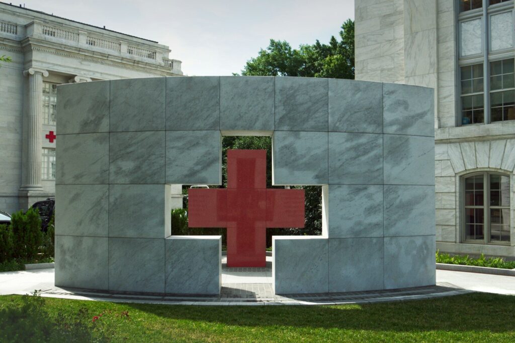 Modern monument with a red cross cutout